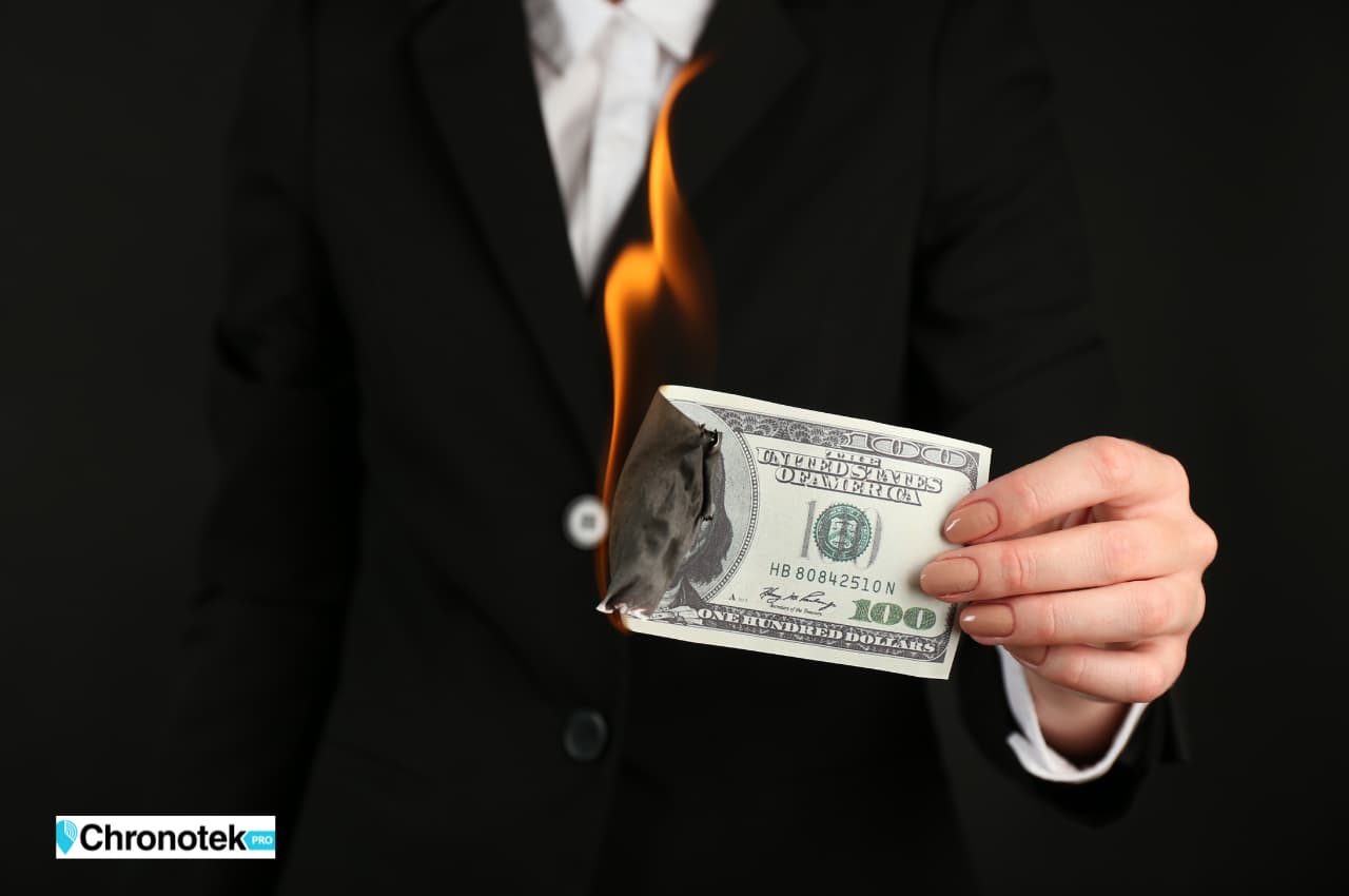 business owner burning a hundred dollar bill