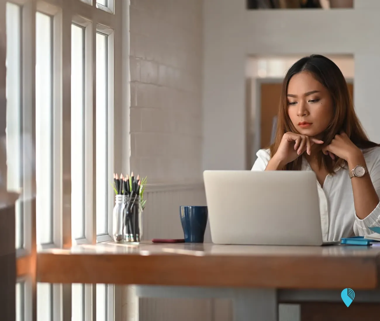 company owner sitting at desk drafting a warning about employee time theft