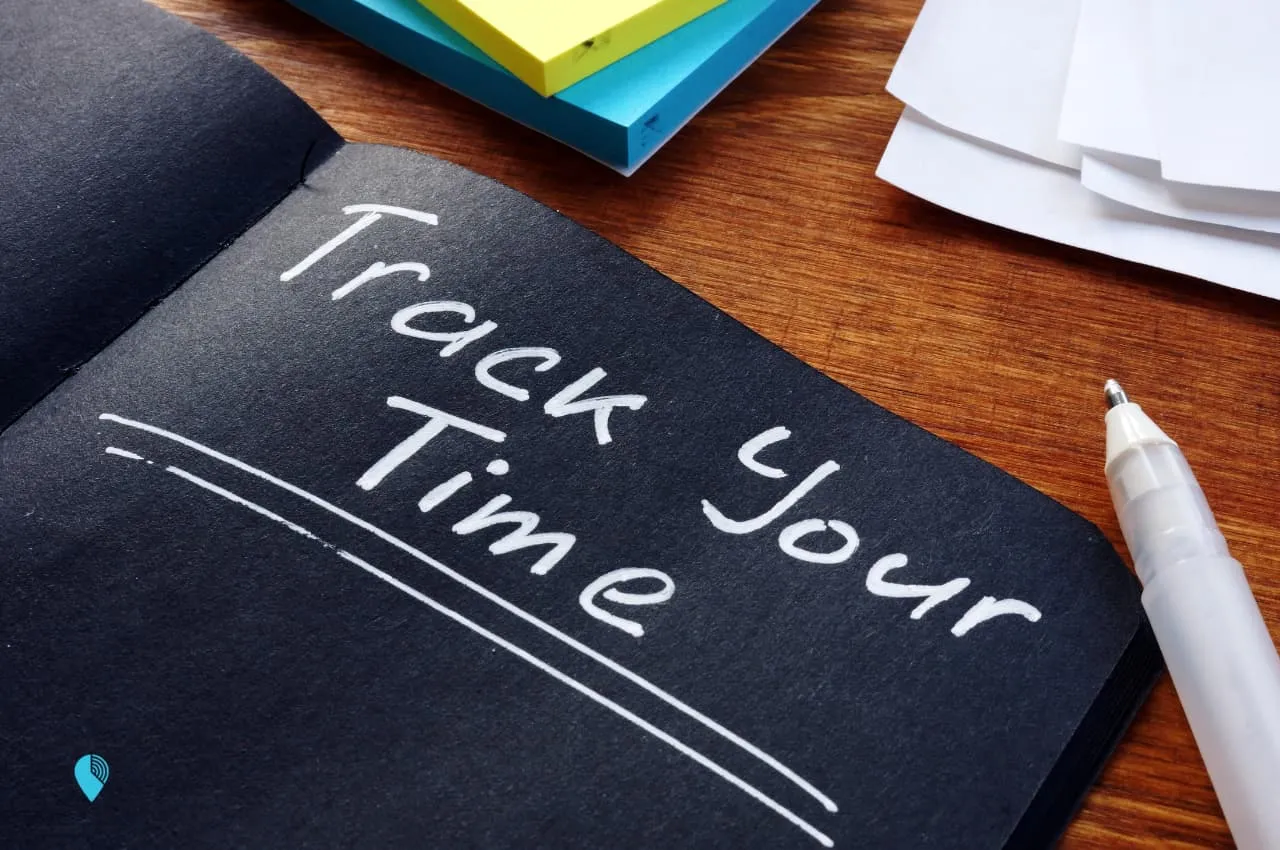 a black notebook with the words "track your time"