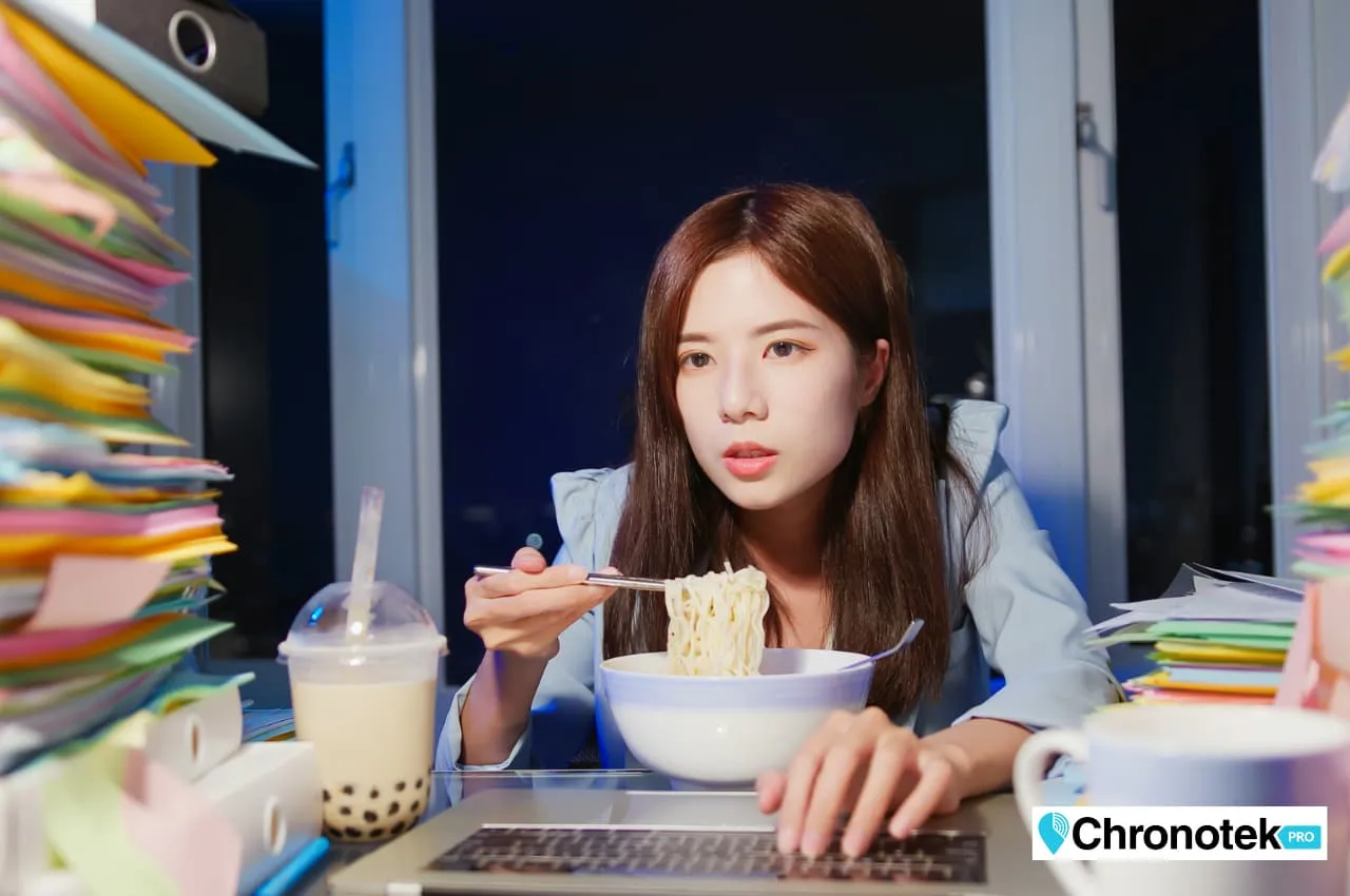 An employee taking a meal break at her desk