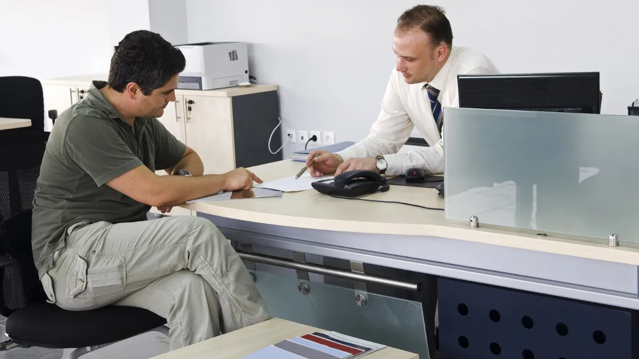 A boss and employee discussing timecard changes